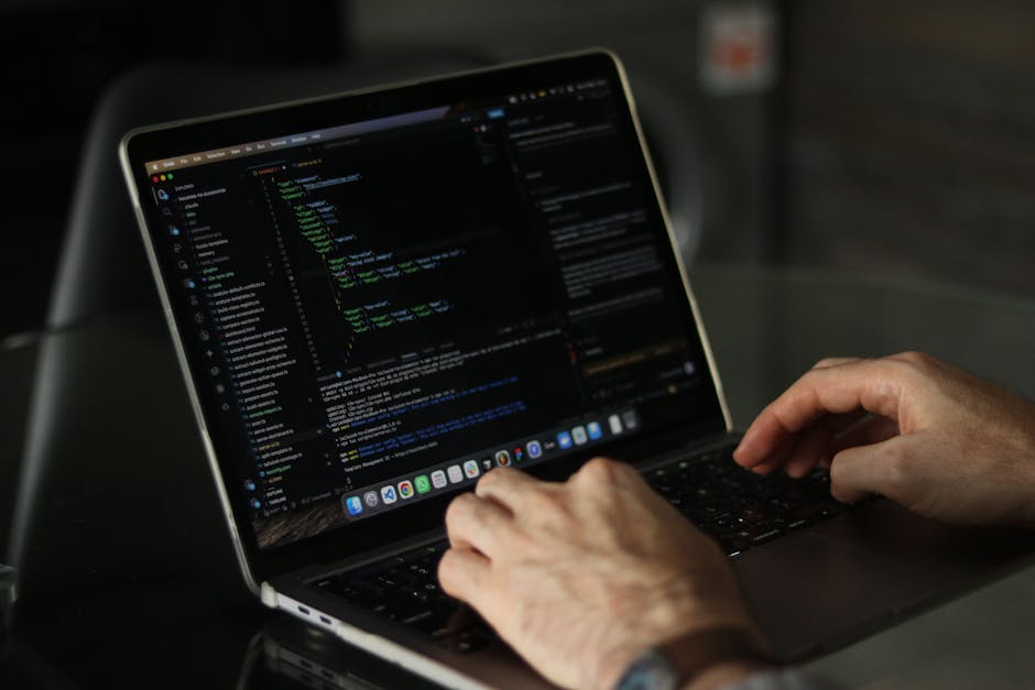 The image depicts a close-up view of a laptop computer displaying lines of code on its screen, positioned on a wooden surface. Next to the laptop, there is a ceramic mug with the text 'This coffee is 